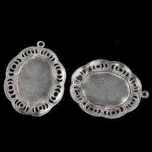 Sterling silver plated brass oval solid back setting for 19x13mm cabochon. Wavy filigree border. 1 ring. Sold individually. b9-2426